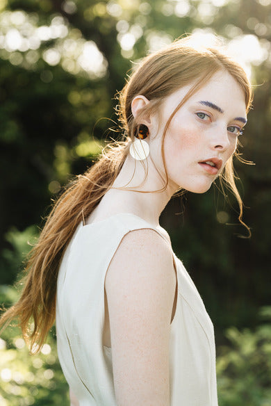 Model wearing Jola Earrings, side view, tortoise acrylic print, acrylic and metal earrings