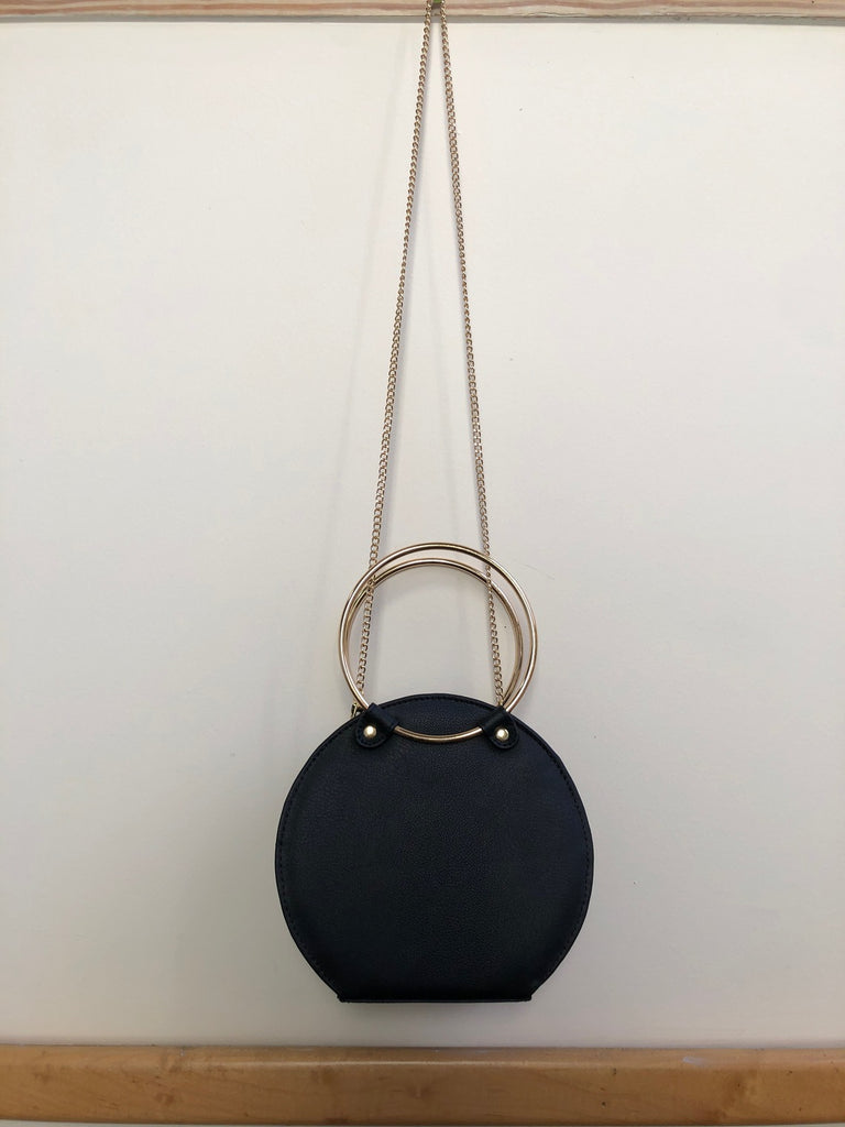Ceibo Handcrafted Ring Bag in Black, side view with chain strap