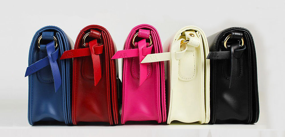 A colorful lineup of Angela Rois philanthropic vegan bags.
