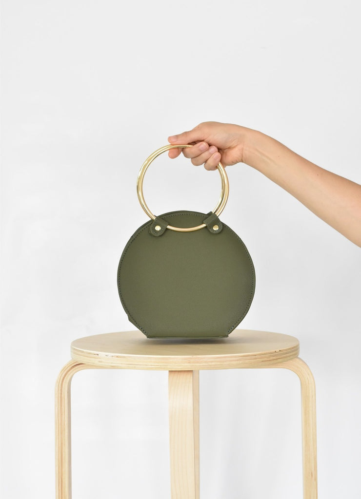 Ceibo Handcrafted Ring Bag in Olive, front view in hand