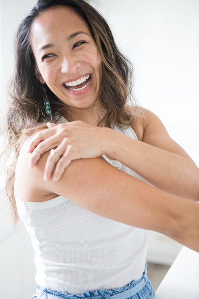 Samudra Skin & Sea Body Butter, being used by smiling model